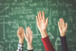 students raising hands