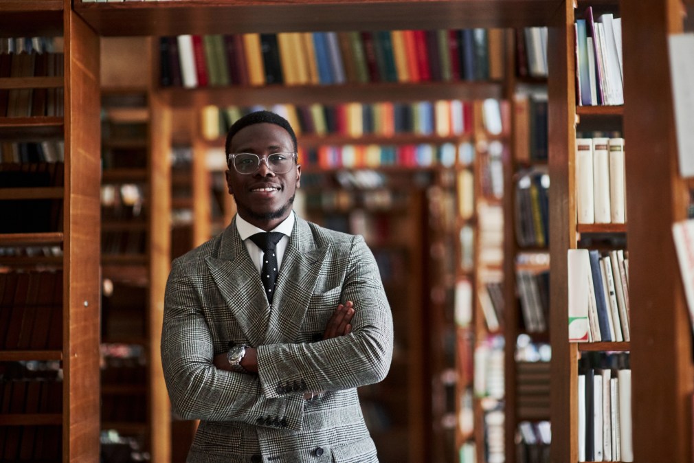 man in suit standing in library