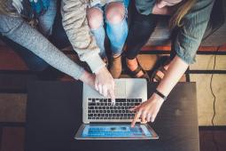 women pointing at laptop screen