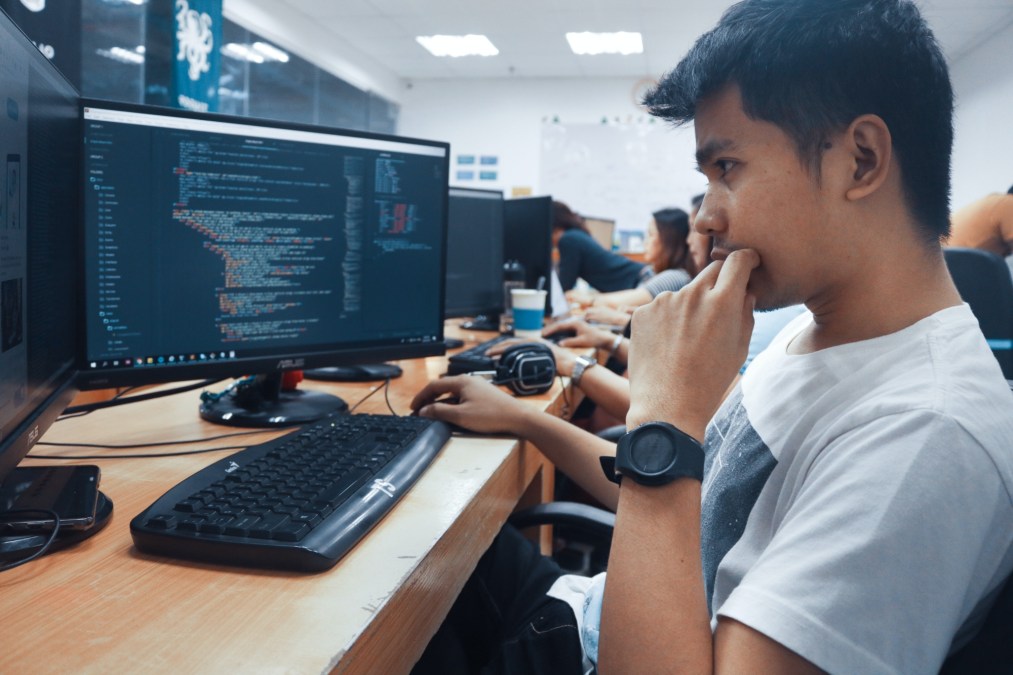 man coding on computer