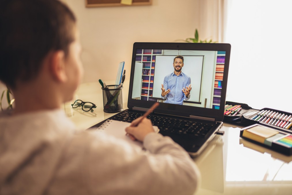 student learning from teacher on laptop