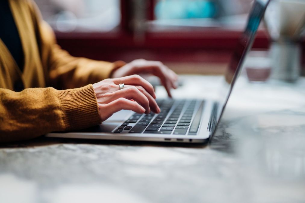 woman typing on laptop