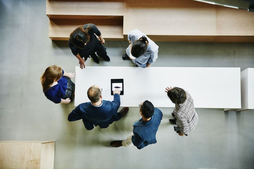 people standing over table