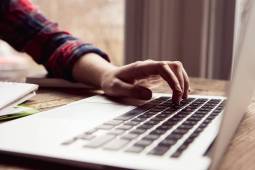 Close up teenage girl using laptop computer